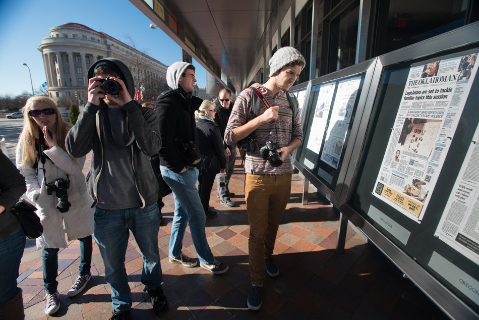 From left, Melissa Richards, Neil Barris, Chuck Miller and Zack Whittman check out front pages of newspapers outside of the Newseum on Pennsylvania Ave. in Washington D.C. on January 19, 2013. The Newseum displays current front pages from newspapers from around the world.