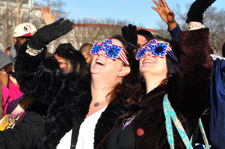 Jill Painter (left) and Kim LaDerek (right), of Highpoint, North Carolina and Buffalo, New York, respectively, are sisters who traveled to Washington D.C. just for the presidential inauguration. They are shown waving to the CNN camera as they watch the live broadcast that is occurring. This is the fourth inauguration that they have attended together.